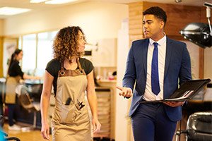 agent discussing professional liability insurance to salon owner